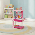 A pink children's play kitchen cart with colorful toy utensils, cups, and food pieces, staged in a bright, sunlit nursery room with a blue wall, white bookshelf, and patterned rug.