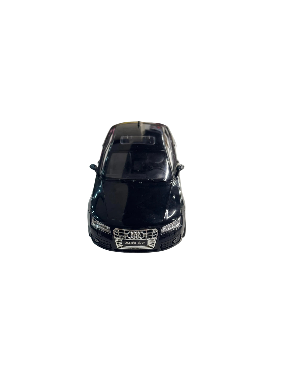 A black Audi A7 diecast model car with a chrome front grille and silver logo, displayed on a light gray surface.